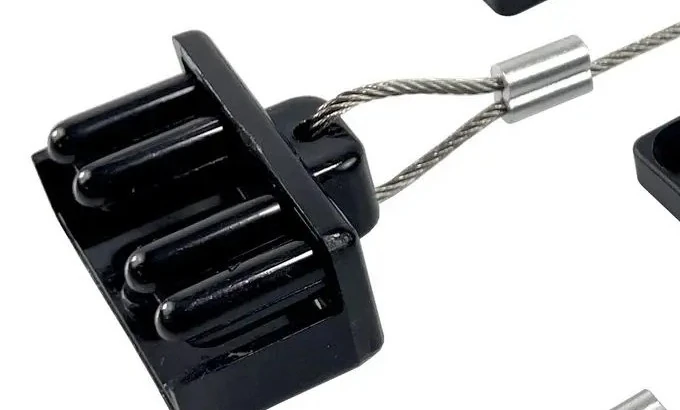 The WRAITH dust cap on its wire rope tether, close up against a plain background