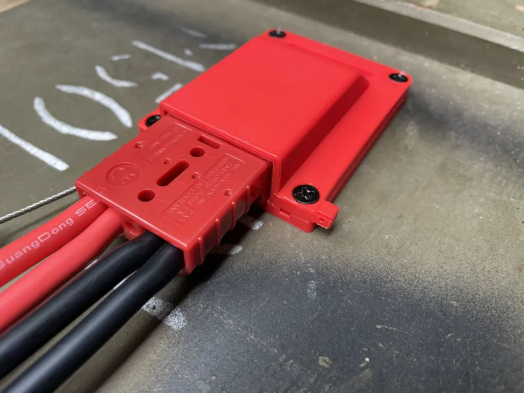 The SORSHA connector mounted and wired in, with heavy gauge black cable running from the terminals