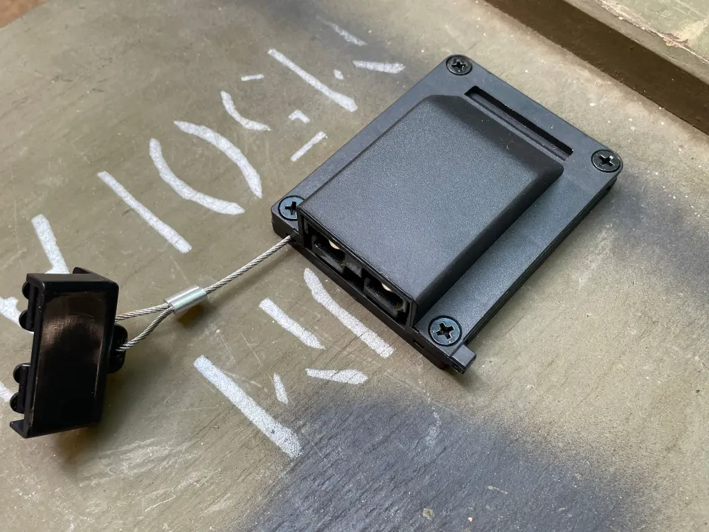 The WRAITH riser base mounted on a panel with its cable exiting, raising the connector clear of the surface