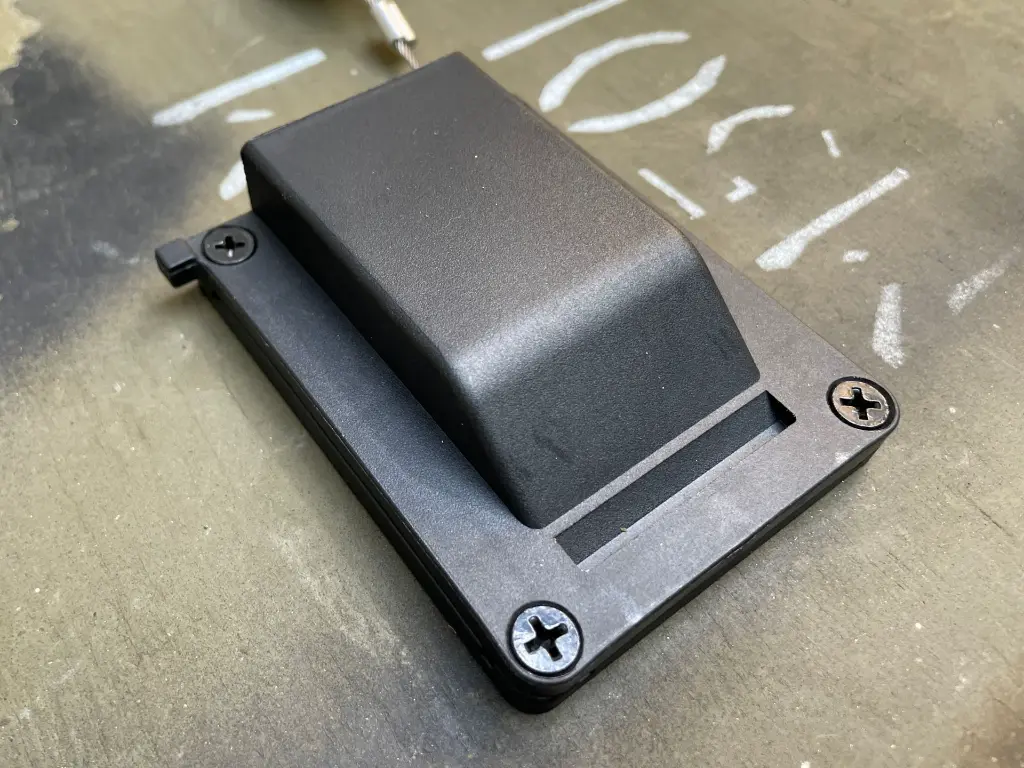 The WRAITH housing mounted with its retaining screw visible, shown from a side angle