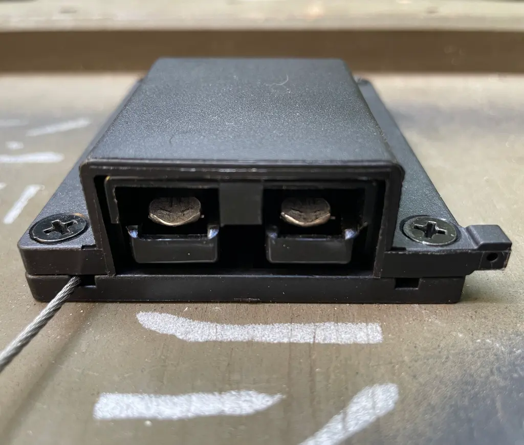 Front view of the WRAITH cover showing the two square terminal pins in the recess