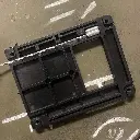 The underside of the WRAITH riser base, showing the wire rope channel and screw holes